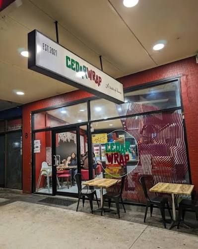 Cedar Wrap storefront on Chapel Rd, Bankstown at night